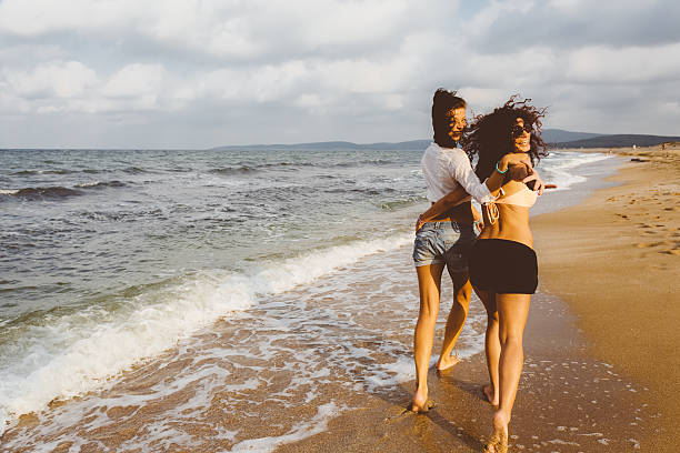 istock Happy playmates walking at the beach 481980264