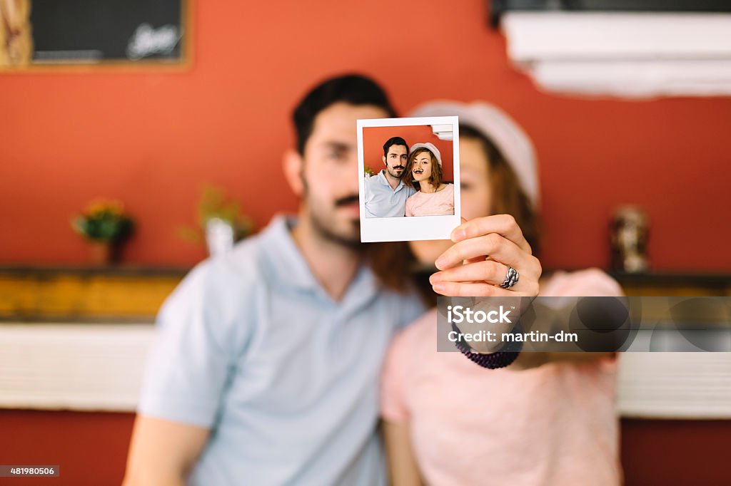 Young couple holding instant photo Polaroid selfie of a young couple Friendship Stock Photo