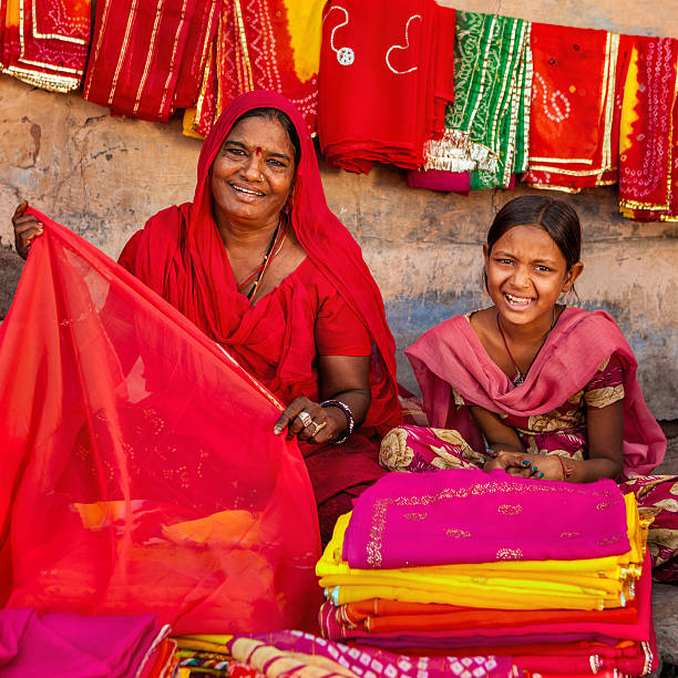 istock Indian women selling colorful fabrics 481981772