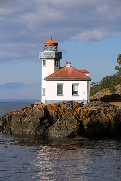 Gleaming Beacon The Lime Kiln historic lighthouse on San Juan Island, in Washington State.   lime kiln lighthouse stock pictures, royalty-free photos & images
