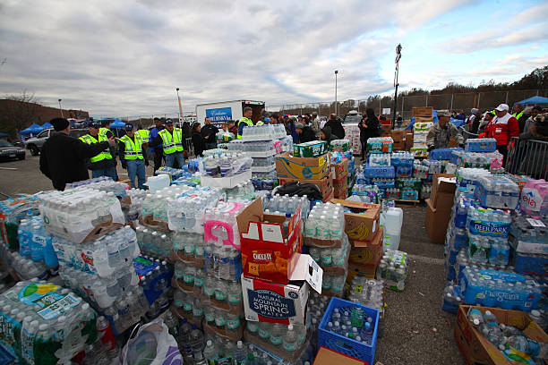 Hurrican Sandy relief, Staten Island Staten Island - New York - USA - November 4 2012: National guard & Red Cross brought tons of supplies to New Dorp high school to aid hurricane Sandy victims. Piles of bottled water stacked for distribution emergency management stock pictures, royalty-free photos & images