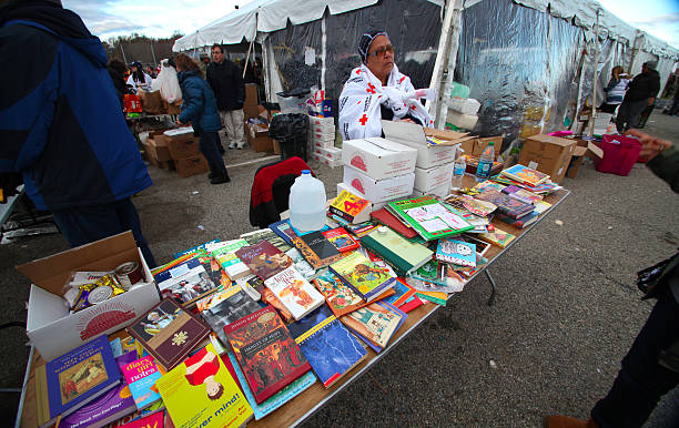 Hurrican Sandy relief, Staten Island Staten Island, New York - USA - November 4 2012: Red Cross & National Guard provide relief to victims of Hurricane Sandy at New Dorp High School field with books for children available on table hurrican stock pictures, royalty-free photos & images