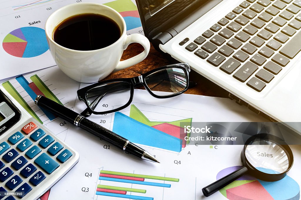 Laptop on Desk office and Graph analysis spreadsheet, Business finance 2015 Stock Photo