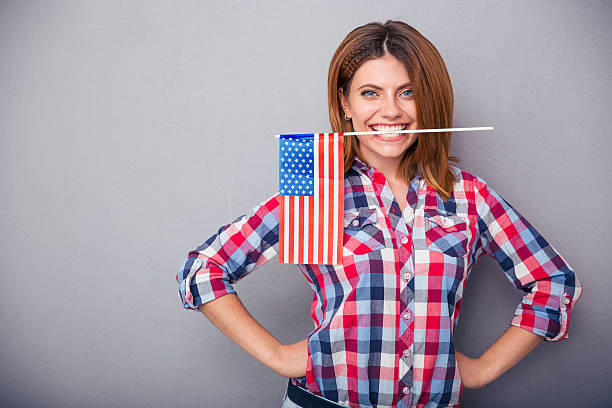 istock Woman holding USA flag in teeth 481990512