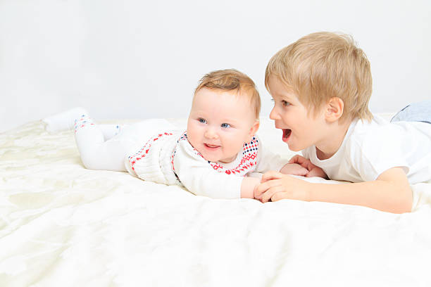 istock little boy talking to newborn sister 481991621