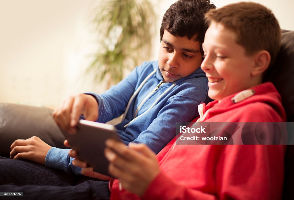 two boys having tablet fun boys having fun with technology 14-15 Years Stock Photo