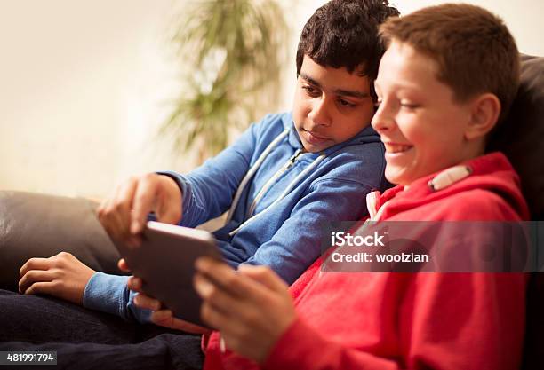 Two Boys Having Tablet Fun Stock Photo - Download Image Now - 14-15 Years, 2015, Busy