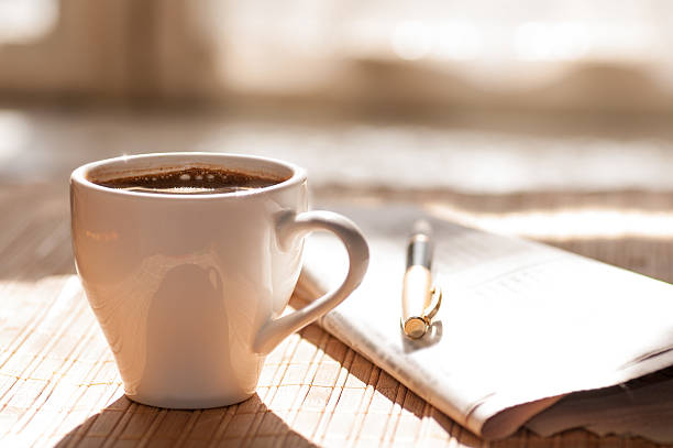 istock Cup of black coffee, newspaper and a pen 481991864