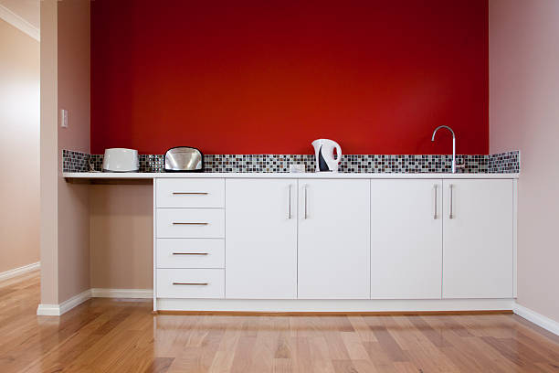 Kitchenette An indoor kitchenette, in an Australia domestic/office residence.  red kitchen cabinets stock pictures, royalty-free photos & images