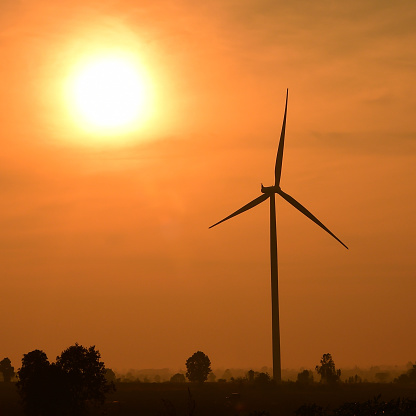 Wind turbines silhouette at sunset.  