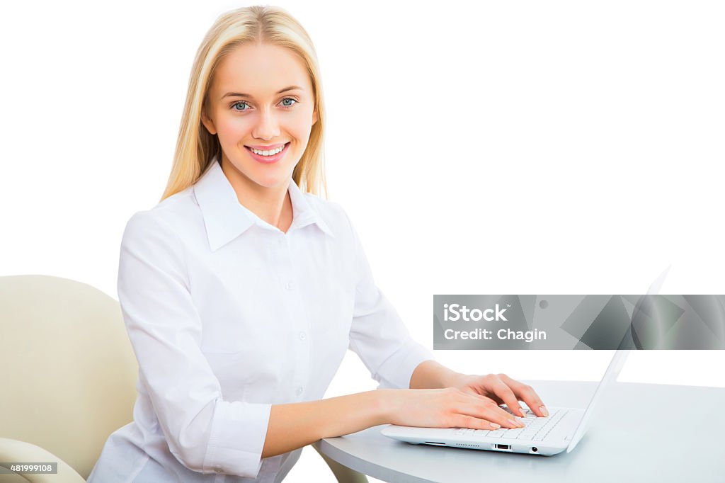 Young business woman using laptop Portrait of a young business woman using laptop at office 2015 Stock Photo