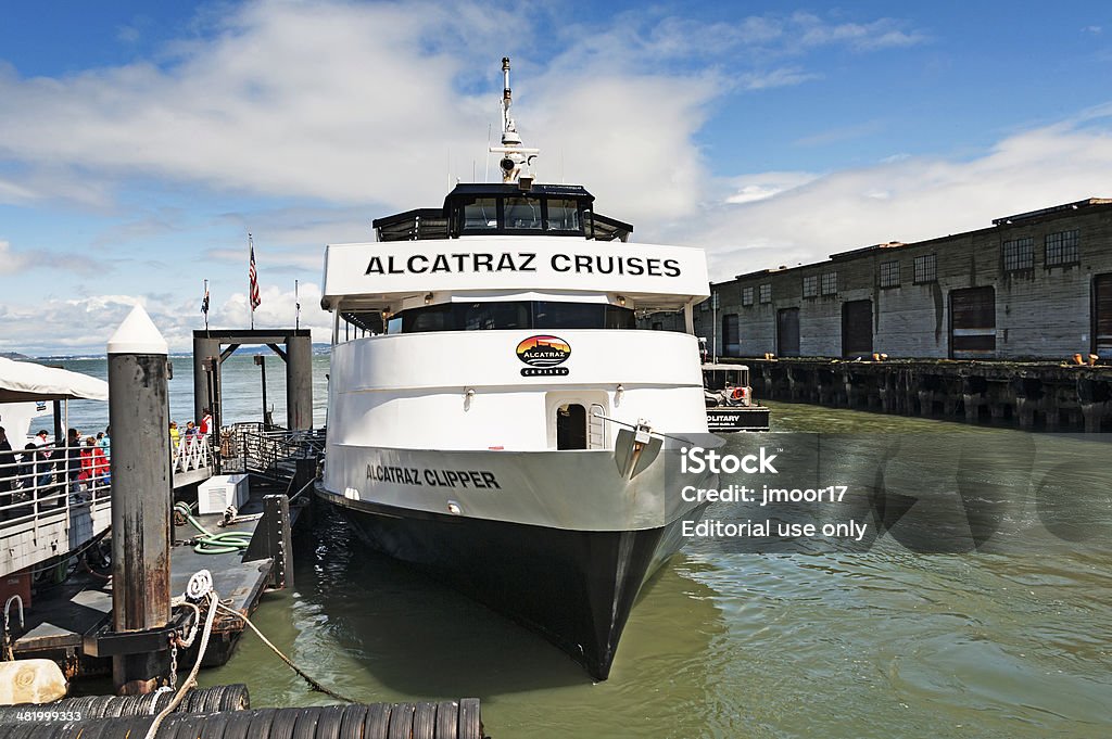 Alcatraz Cruises San Francisco, California, USA - March 26, 2014: This boat named the Alcatraz Cruises is the licensed operator for transporting visitors to Alcatraz Island for visiting this famous landmark, you can see many visitors boarding this boat for their trip to the island. With permission and a ticket from Alcatraz Cruises t hey are not permitted on this beautiful day it was perfect for a ride to Alcatraz and everyone enjoyed the experience. Adult Stock Photo