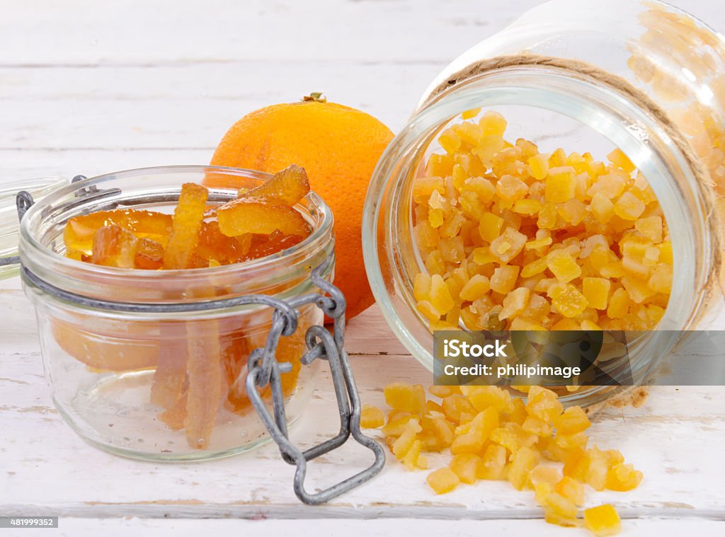 candied oranges cut into pieces candied oranges cut into pieces on the white wooden table 2015 Stock Photo