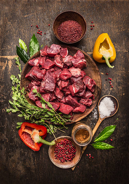 istock Raw meat sliced in cubes and ingredients for beef stew 481999712