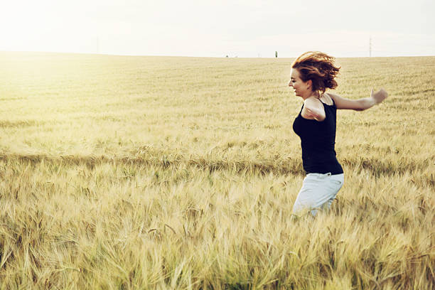istock Crazy woman is jumping in the wheat field 481999824