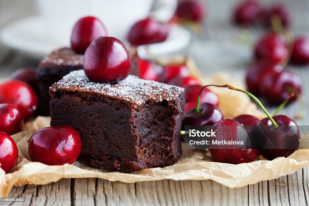 Brownies with fresh berry Homemade brownies with fresh berry and cup of tea on rustic old wooden background, selective focus 2015 Stock Photo