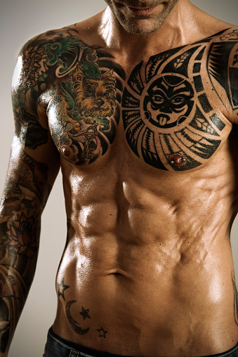 Muscled tattooed male torso