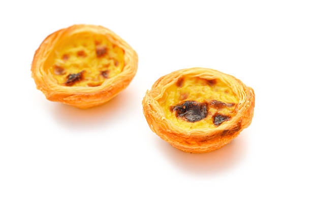 istock two single portuguese egg tarts on a white background 482003758