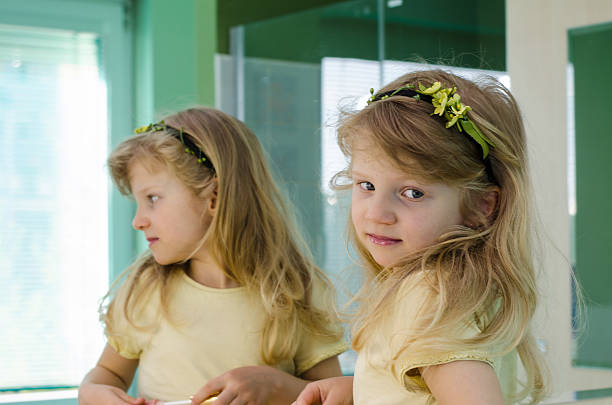 istock blond girl in front of the mirror 482003940