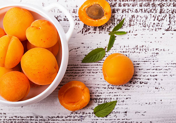 istock Fresh apricots on a bowl, top view 482004596