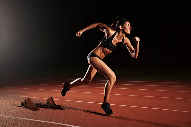 istock Athlete woman running on athletic racetrack 482007346