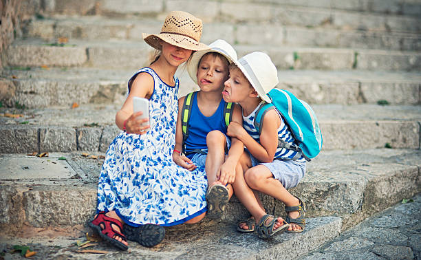 istock Kids tourists taking selfie 482007716