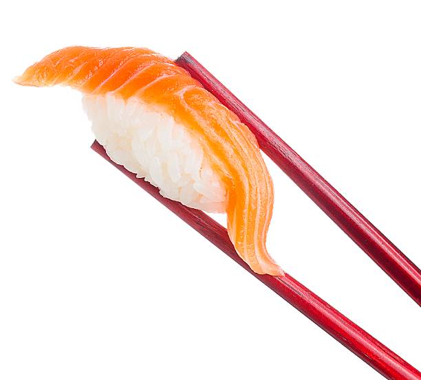 istock Salmon sushi nigiri in chopsticks isolated on white background 482008326