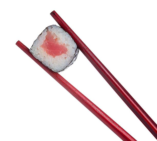 istock Sushi roll in chopsticks isolated on white background 482008362
