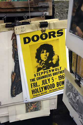 Paris, France - November 15, 2011: The Doors concert poster from 60's has been exhibiting for selling in a book shop's booth on a street of Paris.