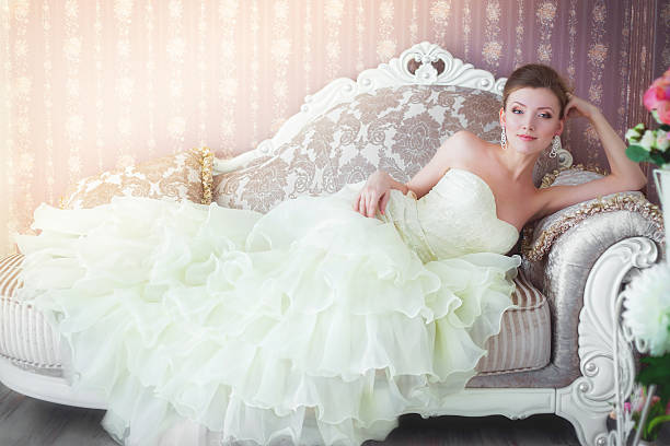 istock The bride sits in a wedding dress on the sofa 482014367