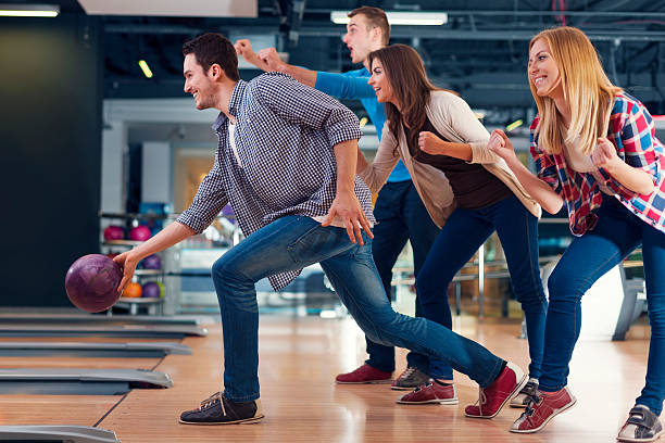 istock Friends cheering their friend while throwing bowling ball 482018221