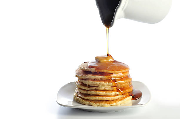 Pancakes with Butter and Syrup on a White Background stock photo