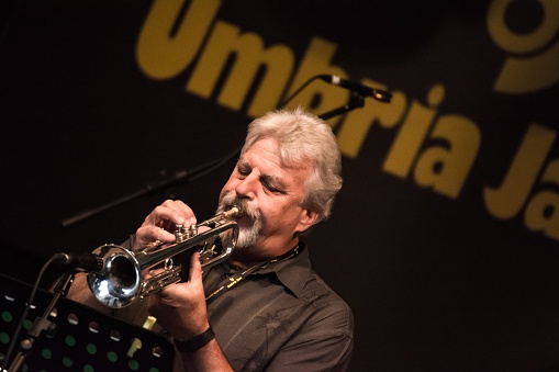 Perugia, Italy - 12 July 2015: A musician plays the trumpet during a concert in the street at the Umbria Jazz Festival