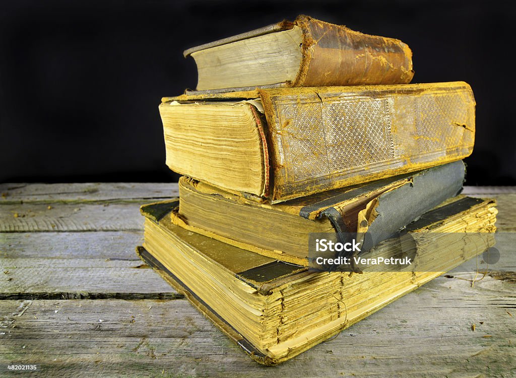 Heap of old books Vintage still life with heap of old shabby books on the wooden table Adventure Stock Photo