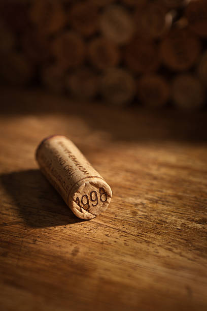 Wine Cork Stoppers with Vintage Year on Rustic Wood Background