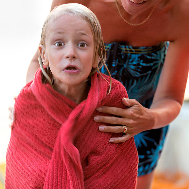 istock Little blond boy after cold dip in the sea. 482021412
