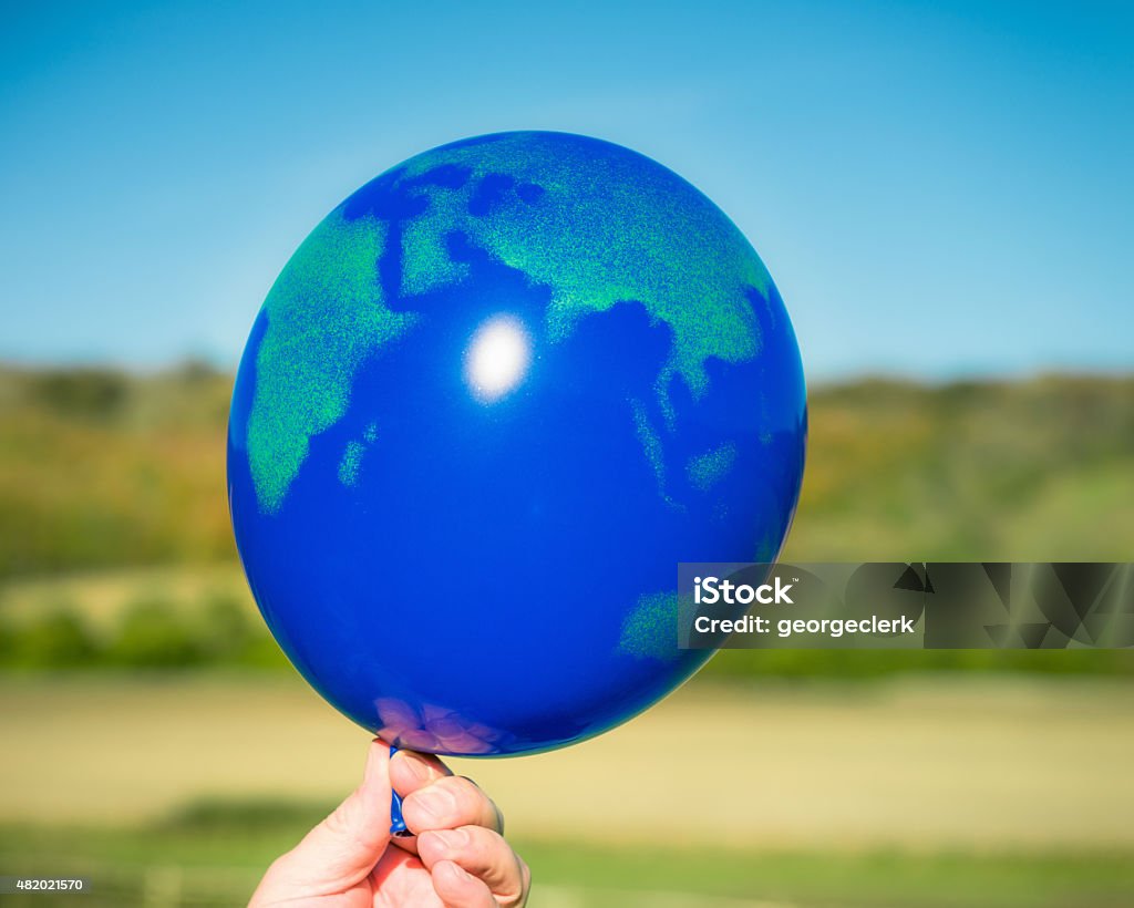 Holding Onto The World Close-up of a world atlas balloon, being held inflated. Balloon Stock Photo