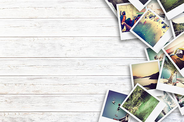 istock Frame with old paper and photos on wooden background. 482021630