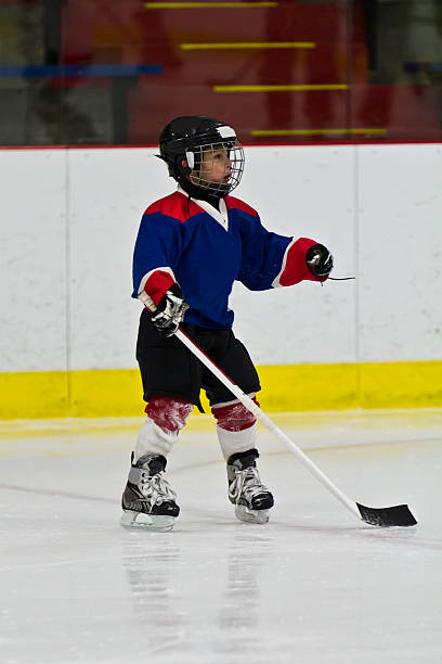 istock Child practicing ice skating and hockey 482021763