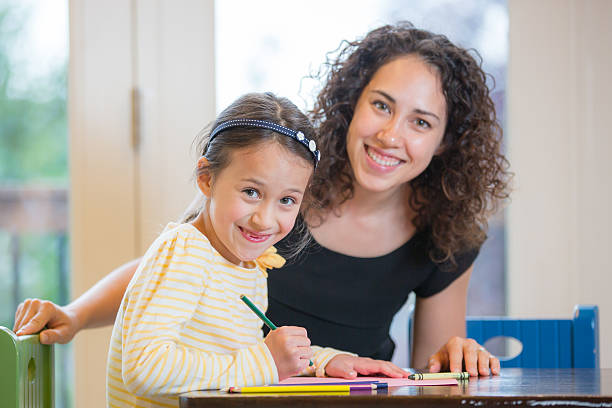 istock Young mother helping her daughter do homework inside their home 482021810
