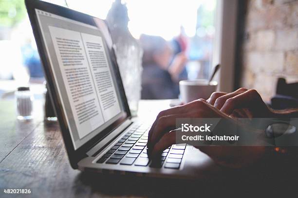 Using A Laptop In A Cafe Stock Photo - Download Image Now - Writing - Activity, Author, Editor