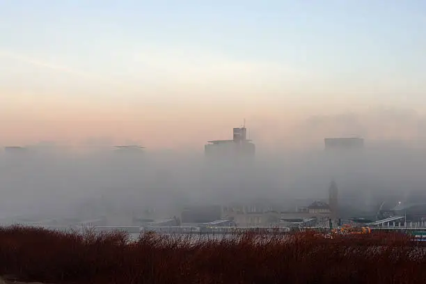 Hamburg Landungsbrücken on a beautiful morning. Heavy fog blocks the view of the skyline.