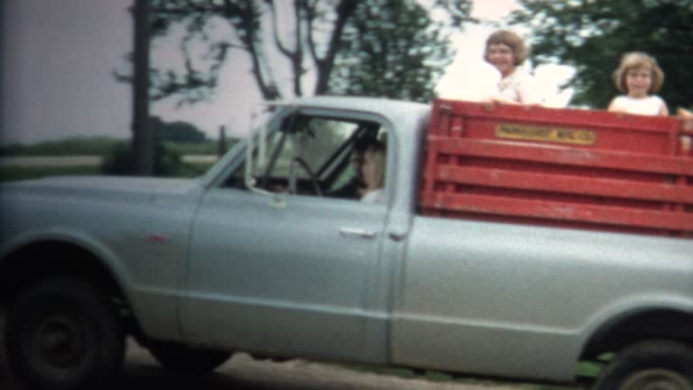 (8mm Vintage) 1966 Girls Riding Back Of Farm Truck in Iowa, USA.