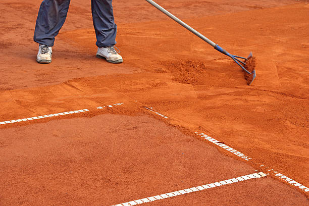 A worker repair the lines on tennis courts