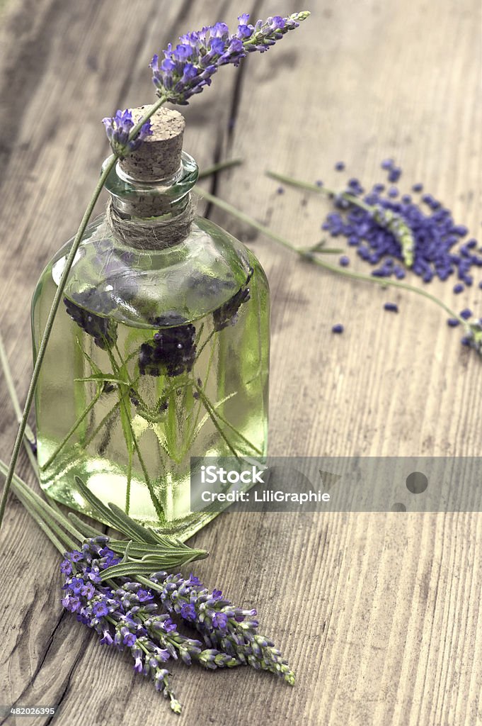 essential herbal lavender oil with fresh flowers essential herbal lavender oil with fresh flowers on wooden background. selective focus Alternative Therapy Stock Photo