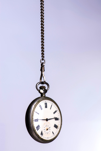 Vintage pocket watch hanging on a chain