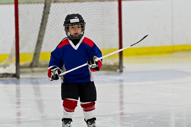 istock Little boy playing ice hockey in an arena 482027765