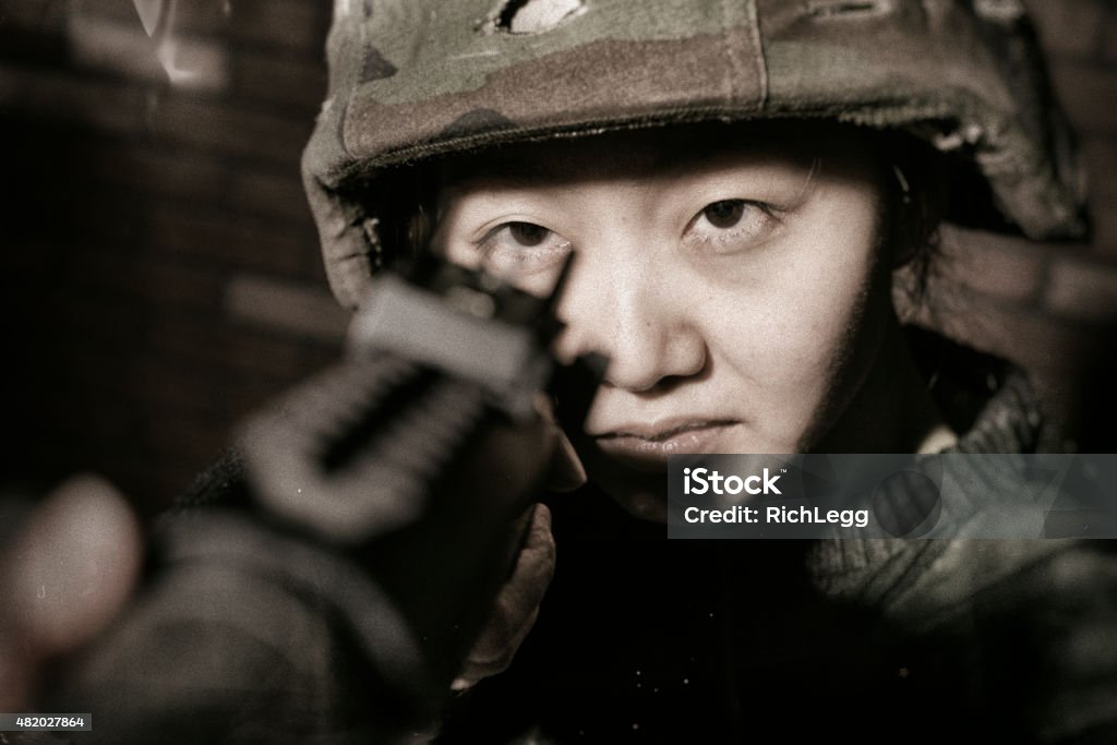 Asian Military Shooter An Asian soldier takes sight with a military rifle. 20-29 Years Stock Photo