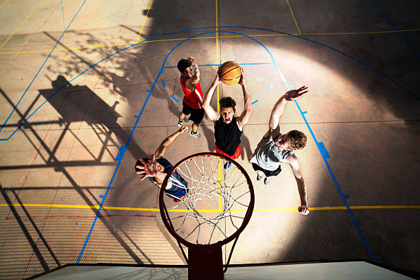 young basketball players playing with energy stock photo