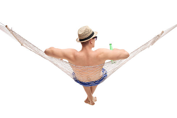 istock Young man lying in a hammock and holding a beer 482030882